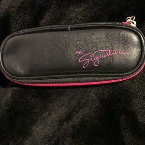 A Mary Kay black and pink lipstick case